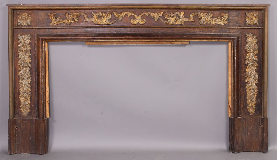 ANTIQUE CARVED OAK FIREPLACE MANTEL MANTLE: A Continental carved oak mantel having a molded outer edge framing relief carved foliate and scroll decoration circa 1900. Having remnants of paint decoration. Opening: 34.5" x 55" Ht: 45" Width: 79.2