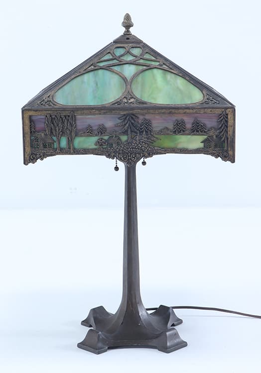 AN ART NOUVEAU GILT METAL SLAG GLASS LAMP DEPICTIGN HOUSES ON A BODY OF WATER.: An Art Nouveau gilt metal slag glass lamp depictign houses on a body of water. Ht: 24.5" Wd: 14.25" Dpth: 14.25"