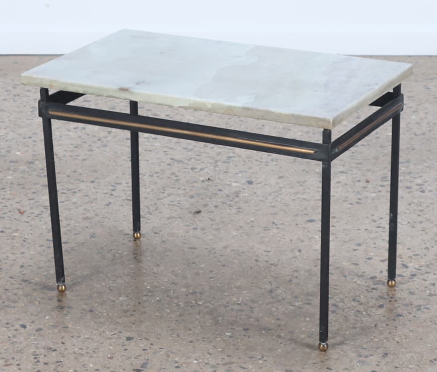 A PETITE IRON TABLE HAVING A MARBLE TOP AND BRASS ACCENTS.: A petite iron table having a marble top and brass accents. Ht: 17.5" Wd: 25" Dpth: 15"