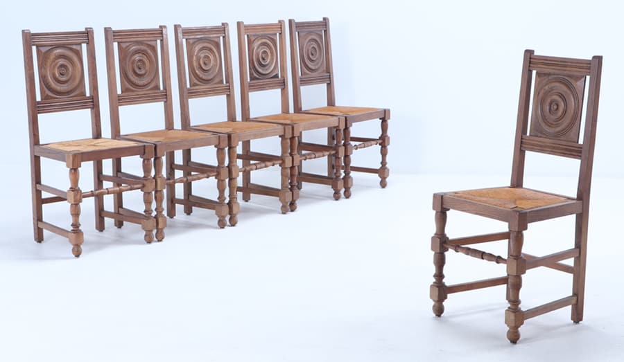 A SET OF SIX FRENCH OAK DINING CHAIRS ATTRIBUTED TO CHARLES DUDOUYT HAVING RUSH SEATS CIRCA 1940. (1 of 7)