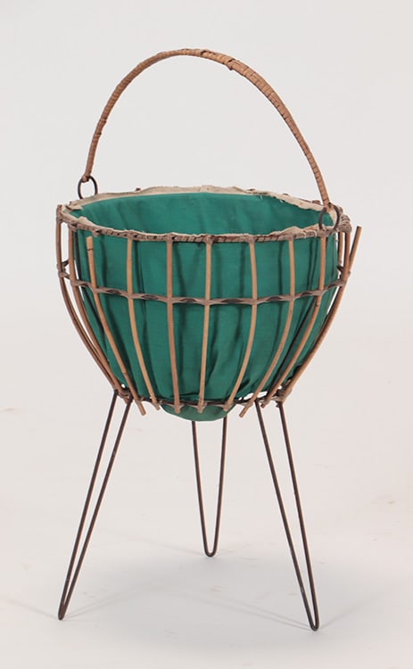 A FRENCH RATTAN BASKET ON IRON LEGS C 1950.: A French rattan basket on iron legs C 1950. Ht: 27.5" Wd: 14.5"