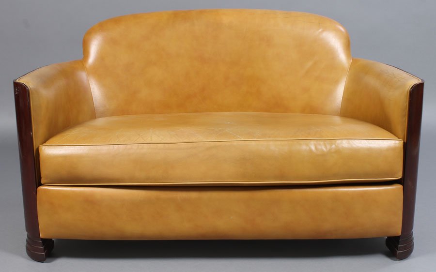 ART DECO LEATHER LOVE SEAT LOOSE CUSHION: A good Art Deco style leather love seat having arched back and continuous curved arms over loose cushion and stacked feet. Ht: 29" Width: 48" Depth: 25"
