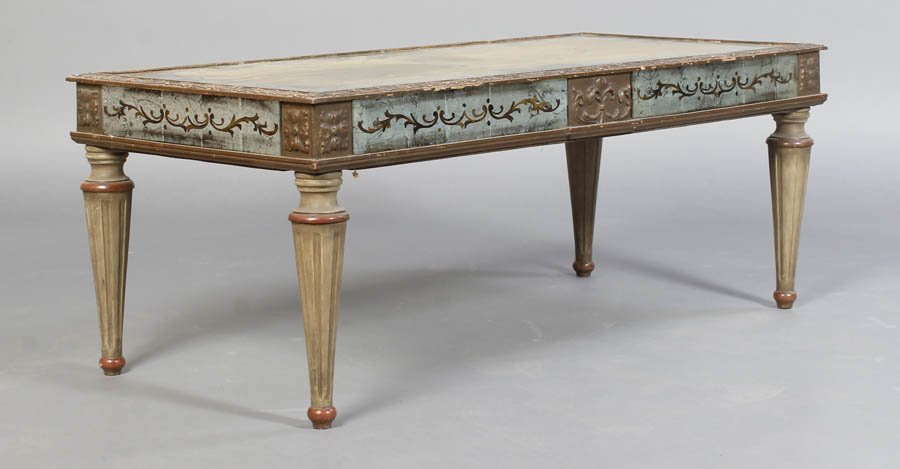 JANSEN EGLOMISE SILVER GILT MIRRORED TABLE: Jansen eglomise silver and gilt decorated coffee table having gadrooned top edge and decorated mirrored apron over turned and fluted legs. Circa 1940. Ht: 16.5" Width: 42" Depth: 20"