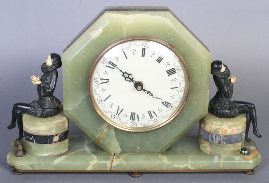 ART DECO ONYX DESK CLOCK: An amusing Art Deco onyx desk clock featuring two decorative Pierrettes on either side circa 1930. Clock movement adapted to quartz. Ht: 10.5" Width: 16.5" Depth: 3.75"