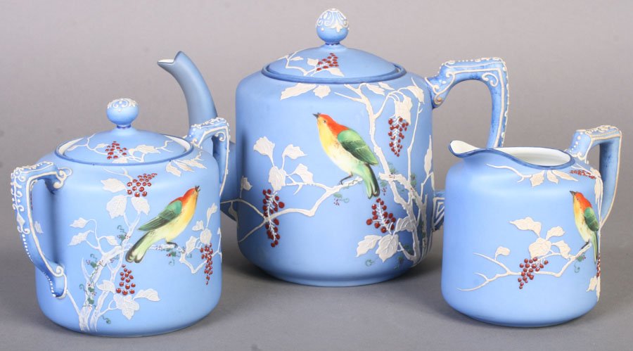 3 PC HAND PAINTED NIPPON TEA SET MORIAGE: A three piece hand painted Nippon tea set with applied moriage foliate embellishments and painted birds circa 1940. Ht: 6" Width: 8" Depth: 4"