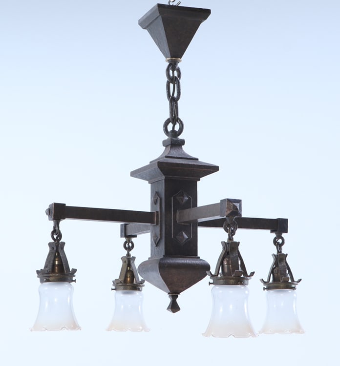 AN ARTS AND CRAFTS HAND HAMMERED IRON FOUR ARM CHANDELIER HAVING QUEZAL ART GLASS SHADES. (1 of 7)