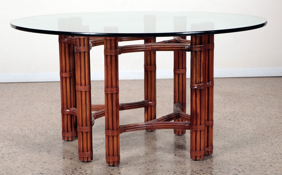 ROUND RATTAN TABLE WITH GLASS TOP: A round rattan table with glass top. Ht: 29" Dia: 55.25"