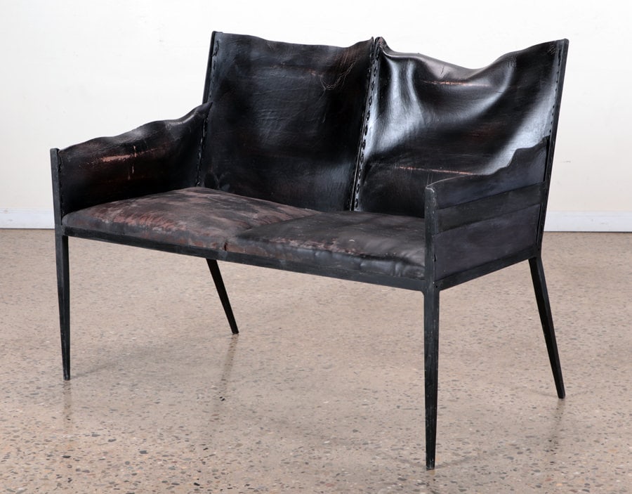 IRON & LEATHER SETTEE IN MANNER OF JEAN-MICHEL FRANK: An iron and leather two seat settee in the manner of Jean-Michel Frank. Ht: 34.5" Wd: 47.25" Dpth: 27.5" Seat: 18.25"