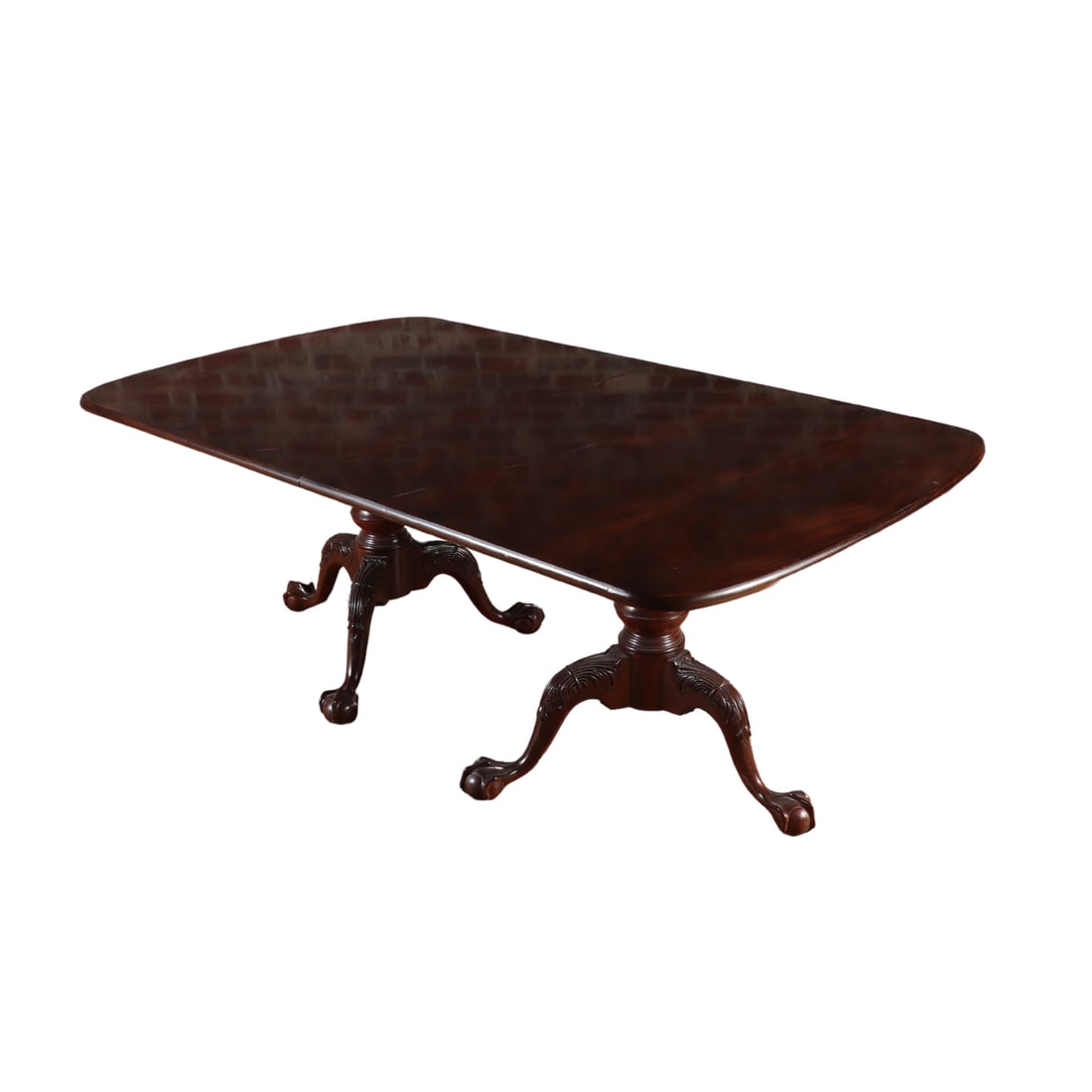 MAHOGANY DINING TABLE HAVING BALL AND CLAW BASES SUPPORTING A CROTCH MAHOGANY TOP WITH TWO LEAVES. (1 of 7)