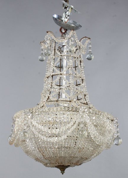 CRYSTAL BASKET CHANDELIER BRONZE FRAME: A crystal basket form chandelier having bronze frame housing three light sockets. Ht: 23" Width: 16"
