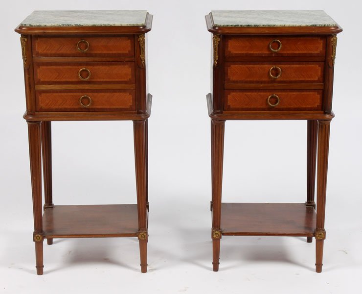 SIMILAR PAIR LOUIS XVI MARBLE TOP SIDE CABINETS: A pair of Louis XVI style marble top side cabinets, each having inset marble tops over chevron and banded drawers and doors circa 1910. Supported on fluted legs with lower shelf over cabinet with marb