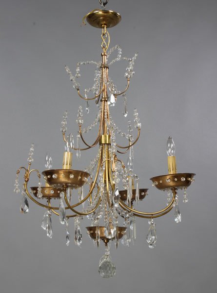 JANSEN BRONZE CRYSTAL CHANDELIER LIGHTING DOME: A Jansen four-arm bronze chandelier having a double-tiered crystal design with pierced dome and faceted crystal cups circa 1930. Ht: 31.5" Dia: 22"