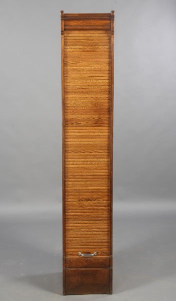 ANTIQUE VICTORIAN OAK FILING CABINET TAMBOUR: A Victorian oak filing cabinet having a tambour sliding door revealing fifteen drawers circa 1900. Cabinet is finished on all four sides. Ht: 78" Width: 14.5" Depth: 17.5"