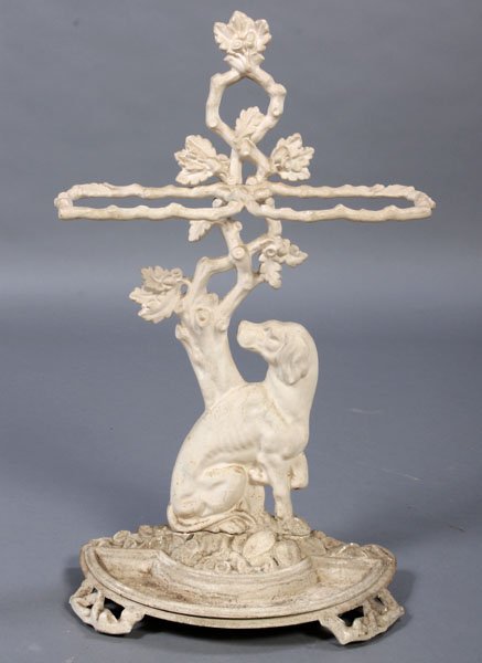 COLEBROOKDALE STYLE DOG IRON UMBRELLA STAND: A Colebrookdale style cast iron figural umbrella stand marked "N. Martin A. Hux" having a seated dog and tree back panel with faux bois rings. Ht: 29" Width: 18" Depth: 9"