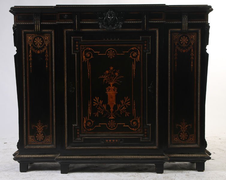 ANTIQUE VICTORIAN EBONIZED INLAID PARLOUR CABINET: Antique Victorian Renaissance Revival ebonized parlour cabinet circa 1870, having a central female mask over a beautifully inlaid door. Maple interior with two adjustable shelves. Ht: 46" Width: 57" D