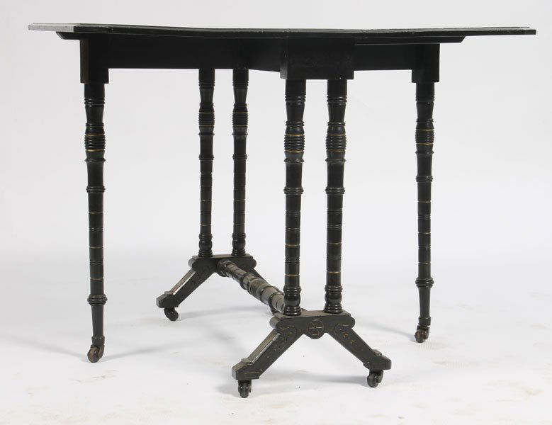 ANTIQUE VICTORIAN EBONIZED DROP LEAF TABLE: American Victorian ebonized drop leaf table having incised gilt decoration supported on turned legs circa 1880. Ht: 27" Width: 36" Depth: 30"