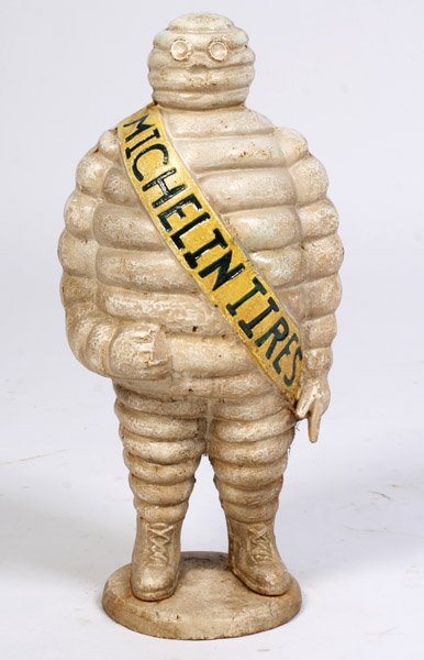 CAST IRON MICHELIN MAN TIRE TRADE FIGURE: A cast iron Michelin Man trade figure. Ht: 22.5" Width: 10.5"
