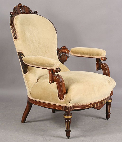 ANTIQUE AMER. REN REV. ROSEWOOD GILT CHAIR: Antique American Renaissance Revival rosewood incised and gilt chair having a carved crest over open arms and a generous seat circa 1870. Raised on turned legs. Dimensions: Ht: 38" Width: 31" Depth: 2