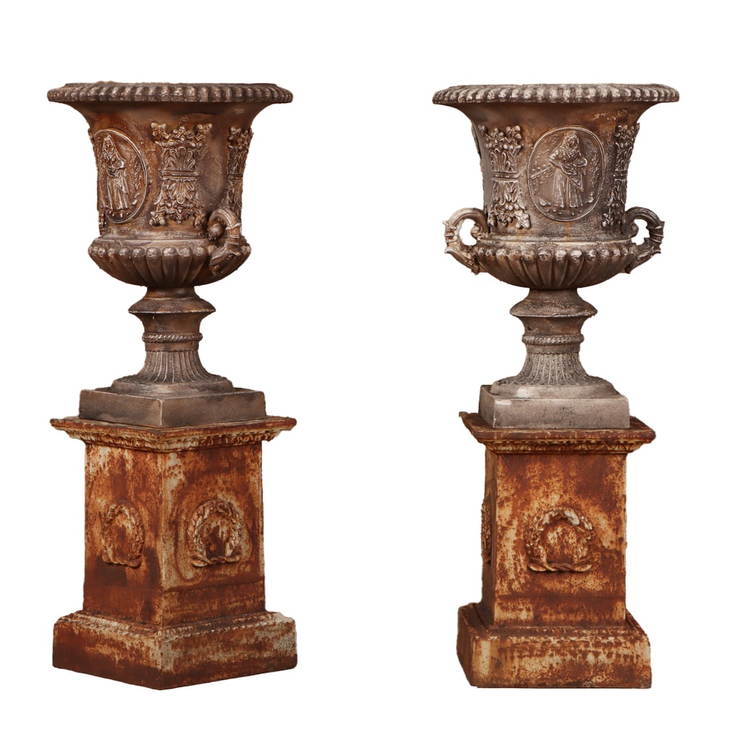 PAIR OF CAST IRON CAMPAGNA GARDEN URNS HAVING FEMALE FIGURES AND DRAGON HANDLES ON SEPERATE BASE: Pair of cast iron Campagna garden urns having female figures and dragon handles on seperate base with wreath decoration. Ht: 46.5" Wd: 19" Dpth: 19"