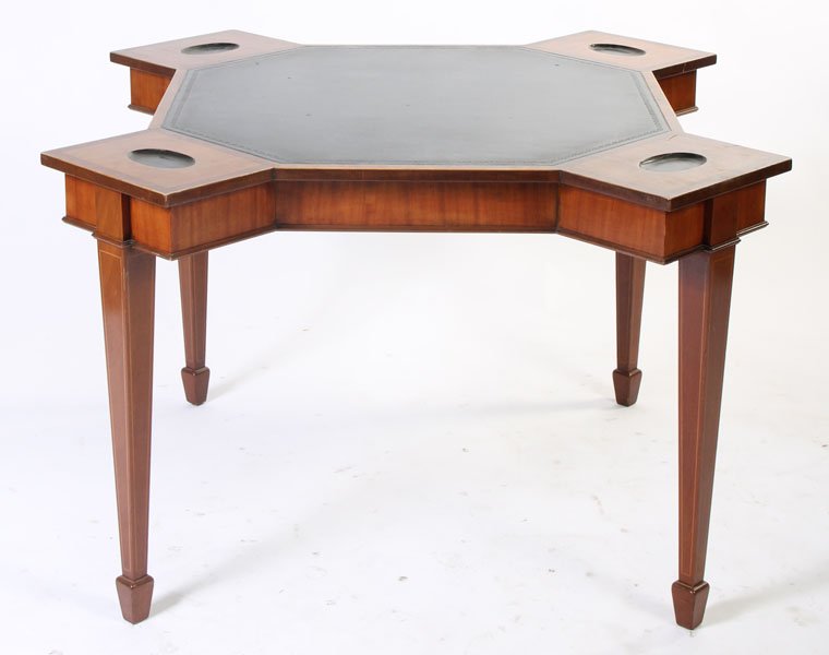 MAHOGANY GAMES TABLE BANDED TOP LEATHER TOP: A mahogany games table having a banded top surrounding an embossed leather top over tapered and string inlaid legs circa 1940. Ht: 30" Width: 53" Depth: 53"