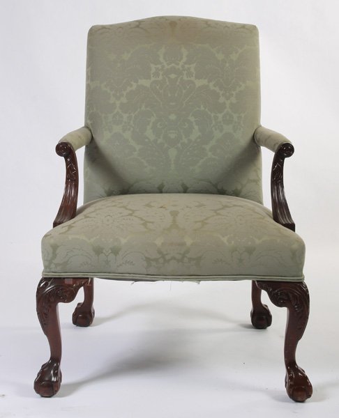 HENREDON LIBRARY CHAIR GREEN UPHOLSTERY: A Henredon library chair having green upholstery resting on fruitwood ball and claw feet. Ht: 40" Width: 28" Depth: 32"