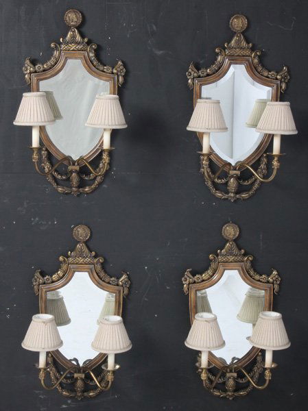 SET 8 LA BARGE BRONZE WOOD MIRRORED 2 ARM SCONCES: A set of eight La Barge bronze and wood shield-form two-arm wall sconces having figural crest and beveled mirror. Measured without shades. Ht: 29.5" Width: 16" Depth: 8.75"