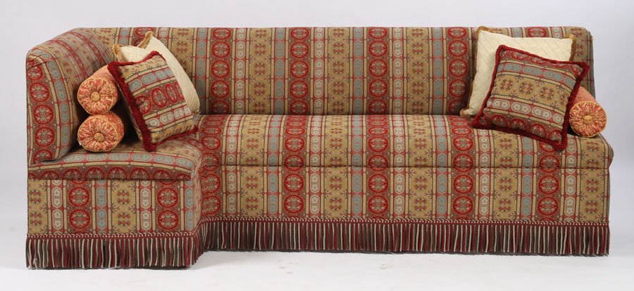 EDWARDIAN STYLE CORNER COUCH WOVEN: An Edwardian style corner couch having woven upholstered and large apron fringe. Ht: 36" Width: 94" Depth: 40"
