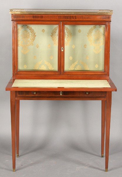 FRENCH LOUIS XVI STYLE VINTAGE DESK VITRINE: A French Louis XVI style vitrine with inset marble top framed by a bronze openwork gallery above glass front doors on a desk base circa 1940. Desk section with chevron and banded inlay over a single d
