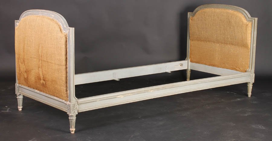 LOUIS XVI STYLE CARVED PAINTED DAYBED C. 1910: A Louis XVI style carved and painted daybed with arched and upholstered ends raised on fluted legs circa 1910. Ht: 34" Width: 35" Depth: 81"