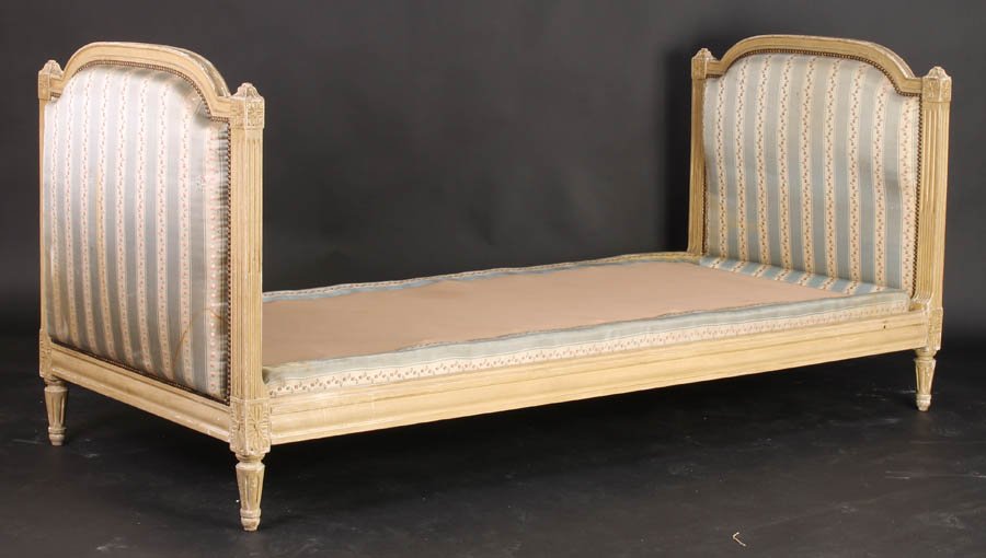 LOUIS XVI STYLE CARVED PAINTED DAYBED C. 1910: A good Louis XVI style carved and painted daybed having arched and upholstered ends, all raised on fluted and turned legs circa 1910. Ht: 37" Width: 35.5" Depth: 80"