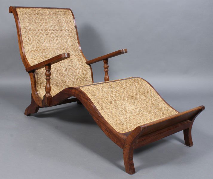 PLANTATION STYLE CHAISE WOVEN GRASS SEAT: A plantation style chaise lounge with curvaceous form with woven grass seat. Ht: 37" Width: 64" Depth: 25"