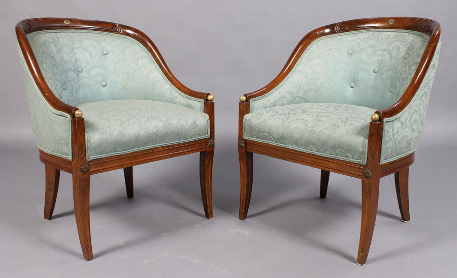 PAIR FRENCH EMPIRE BARREL BACK ARM CHAIRS: A pair of French Empire style bronze mounted barrel back and downswept arm chairs having ball decoration and sabre legs circa 1960. Ht: 31" Width: 23" Depth: 18.5"