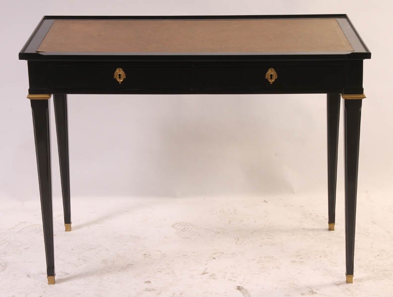 EBONIZED WRITING DESK INSET BLOTTER BRONZE C. 1940: An ebonized writing desk having tray top and inset blotter over two drawers and supported on bronze mounted tapered legs circa 1940. Ht: 30" Width: 39.5" Depth: 20"