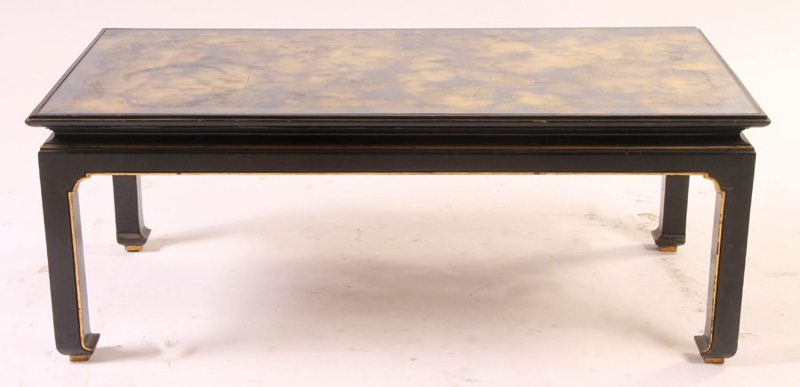 JAMES MONT EBONIZED GILT COFFEE TABLE: James Mont style ebonized and gilt coffee table with a smoked mirrored top circa 1950. Ht: 16.5" Width: 43" Depth: 21.5"