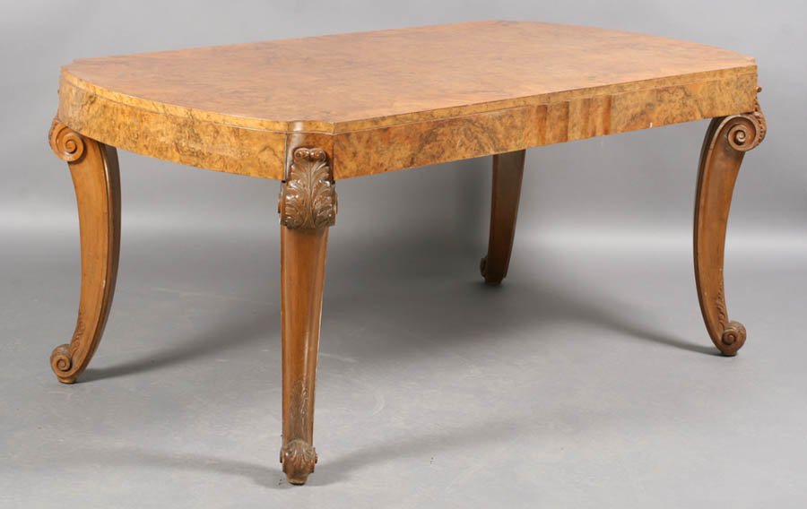 BURL MAHOGANY ART DECO DINING TABLE: A burl walnut Art Deco dining room table with acanthus leaf decoration at tops and bottoms of legs and fluted accents on each side circa 1930. Ht: 31" Width: 72" Depth: 36"