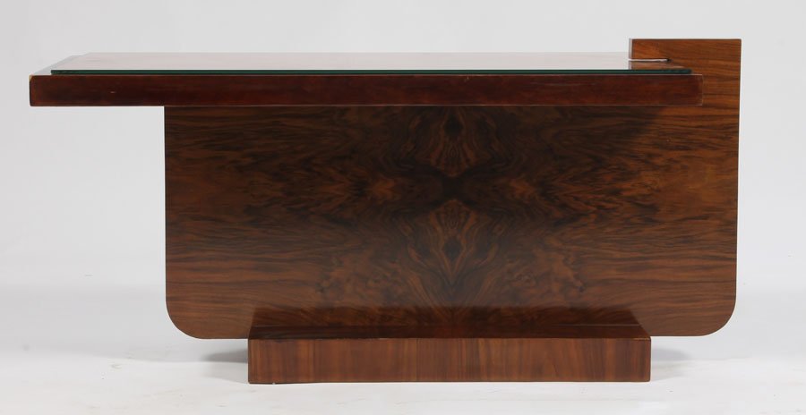 AN ART DECO COCKTAIL TABLE PINK MIRROR C. 1930: An asymmetric Art Deco cocktail table in burl walnut with a pink mirrored top circa 1930. Dimensions: Ht: 20" Width: 45" Depth: 19.5"