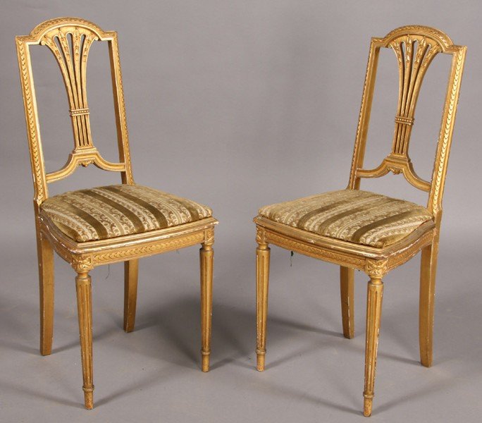 PAIR ANTIQUE FRENCH CARVED GILTWOOD SIDE CHAIRS: Pair of French carved and giltwood side chairs with carved back splats over caned seats on fluted and tapered legs circa 1920. Ht: 36.5" Width: 15" Depth: 14.5"