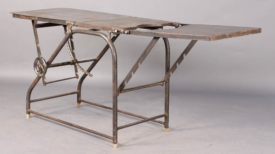 VINTAGE INDUSTRIAL IRON MECHANICAL TABLE: Vintage Industrial cast and wrought iron adjustable mechanical table with multiple levers and positions circa 1910. Ht: 31" Width: 73" Depth: 20"