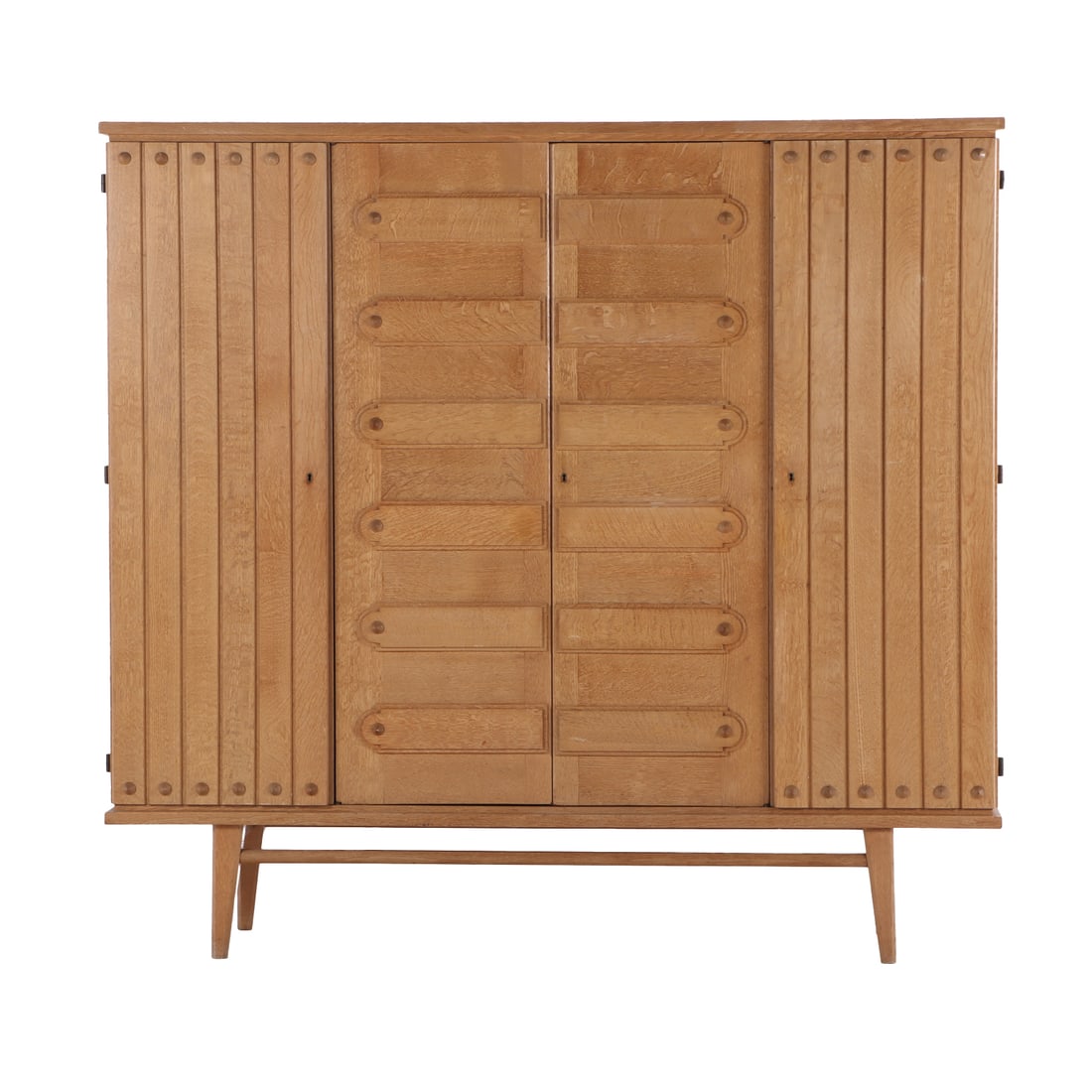 FOUR DOOR FRENCH OAK CABINET C 1950 IN THE MANNER OF GUILLERME ET CHAMBRON.