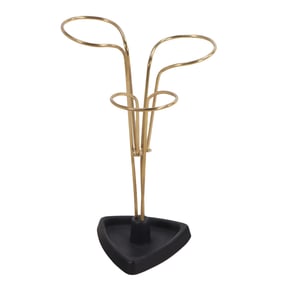 BRASS UMBRELLA STAND RESTING ON A CAST IRON BASE HAVING A SCULPTURAL DESIGN C 1970.