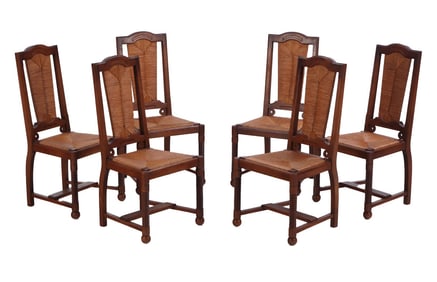SIX FRENCH OAK DINING CHAIRS HAVING RUSH SEATS AND BACKS, TURNED LEGS, RESTING ON BALL FEET IN THE