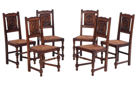 SIX FRENCH OAK AND RUSH SEAT DINING CHAIRS IN THE MANNER OF CHARLES DUDOUYT C 1940.