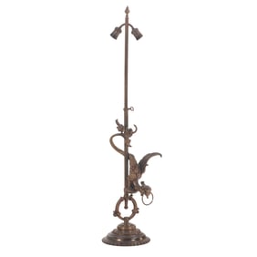 BRONZE ADJUSTABLE FLOOR OR TABLE LAMP HAVING A CAST BRONZE GRIFFIN C 1920.