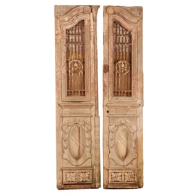 PAIR OF CARVED AND PAINTED WOOD ENTRY DOORS C 1880 WITH IRON INSERTS AND OVAL PANELS.