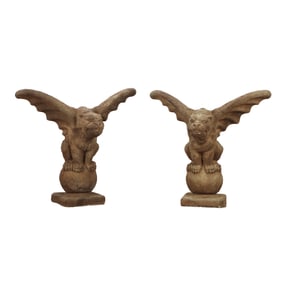 PAIR OF CAST STONE WINGED GARGOYLES ON SPHERES.