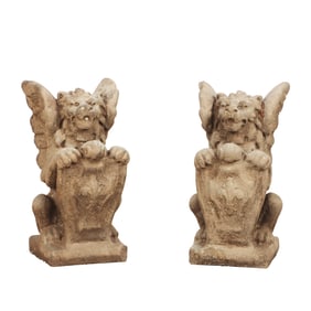 PAIR CAST STONE WINGED GRIFFINS HOLDING SHIELDS.