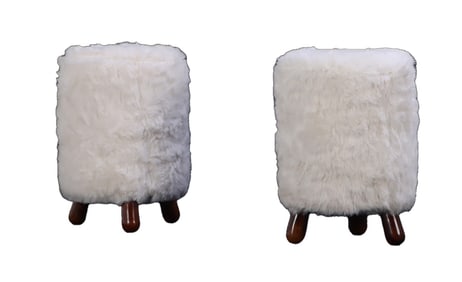 PAIR OF TALL STOOLS UPHOLSTERED IN FAUX FUR WITH WOOD LEGS IN THE MANNER OF JEAN ROYERE.