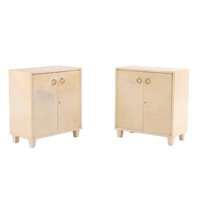 PAIR OF PARCHMENT COVERED TWO DOOR CABINETS WITH BRASS RING DECORATION C 1950.