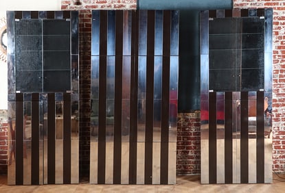 A THREE SECTION STAINLESS STEEL AND LAMINATE WALL UNIT BY PAUL EVANS C 1970. EACH CABINET MADE IN