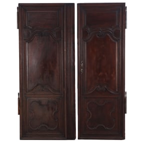 PAIR OF EARLY NINETEENTH CENTURY FRENCH WALNUT CABINET DOORS HAVING A LOCK AND KEY.